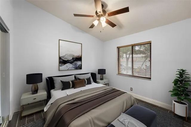 a bedroom with bed and a potted plant