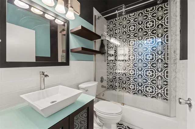 a bathroom with a sink toilet and shower