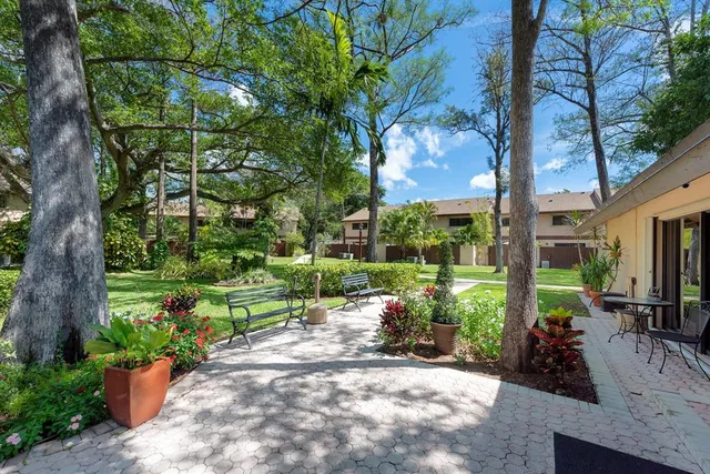 a front view of a house with lots of trees around