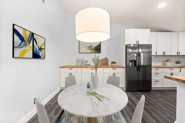 a kitchen with a table and chairs