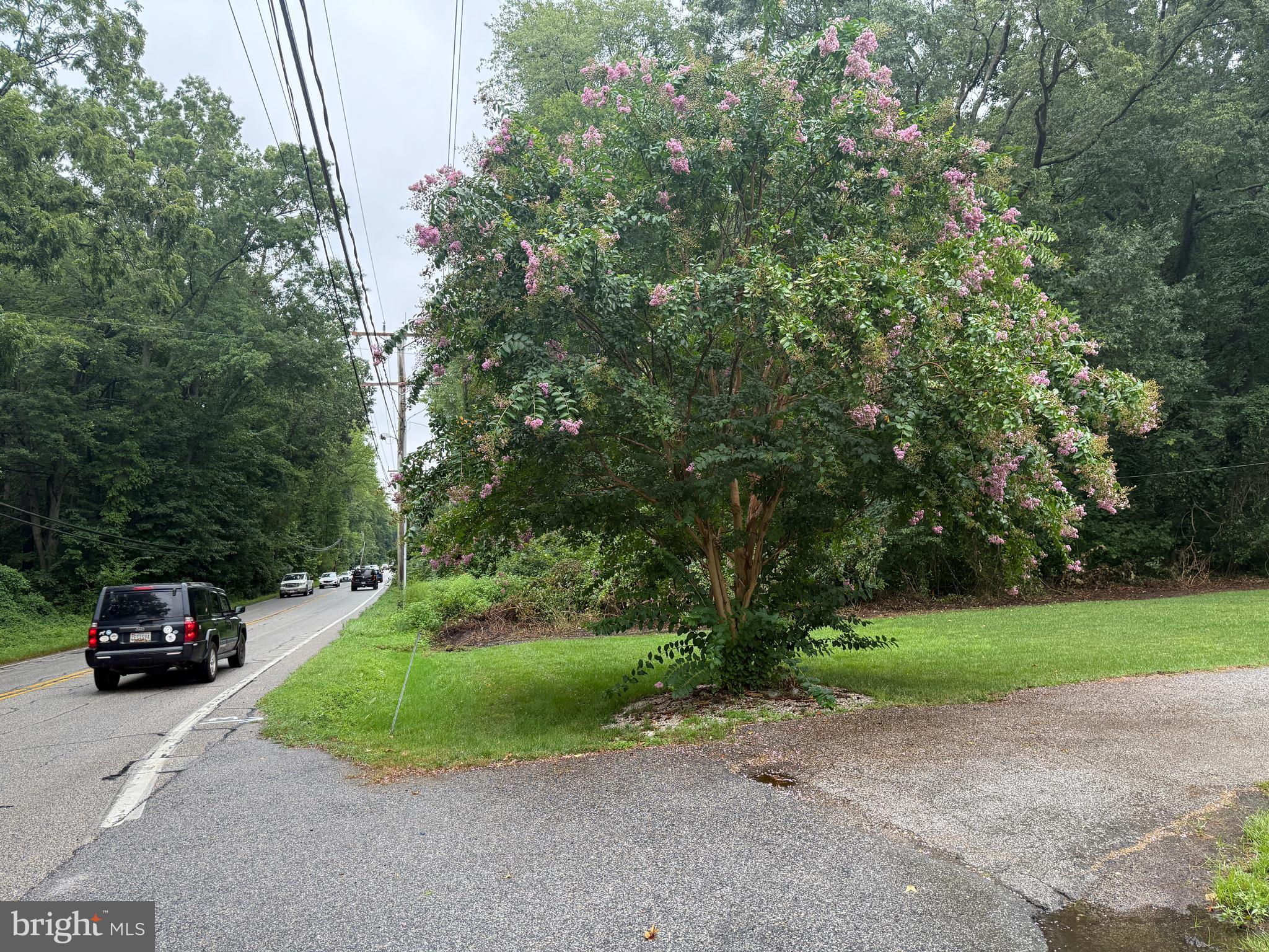 Mayo Road Edgewater, MD 21037 - Photo 14 of 17 a car parked in front of a house and a cars parked on road