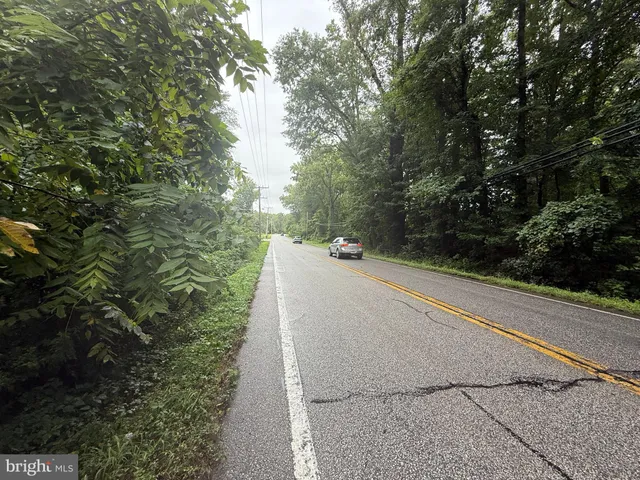 an aerial view of a house with a lush green forest
