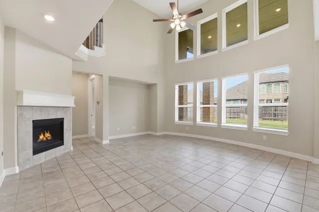 a view of an empty room with window and fire place