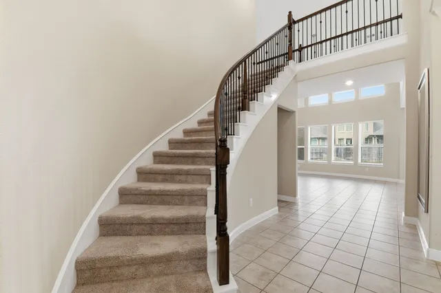 a view of staircase with white walls and windows