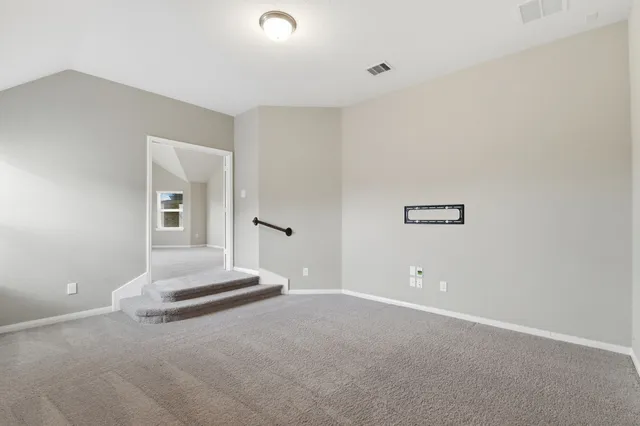 a view of an empty room and a window