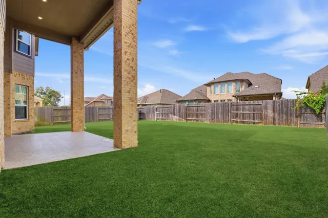 an aerial view of residential houses with outdoor space and swimming pool