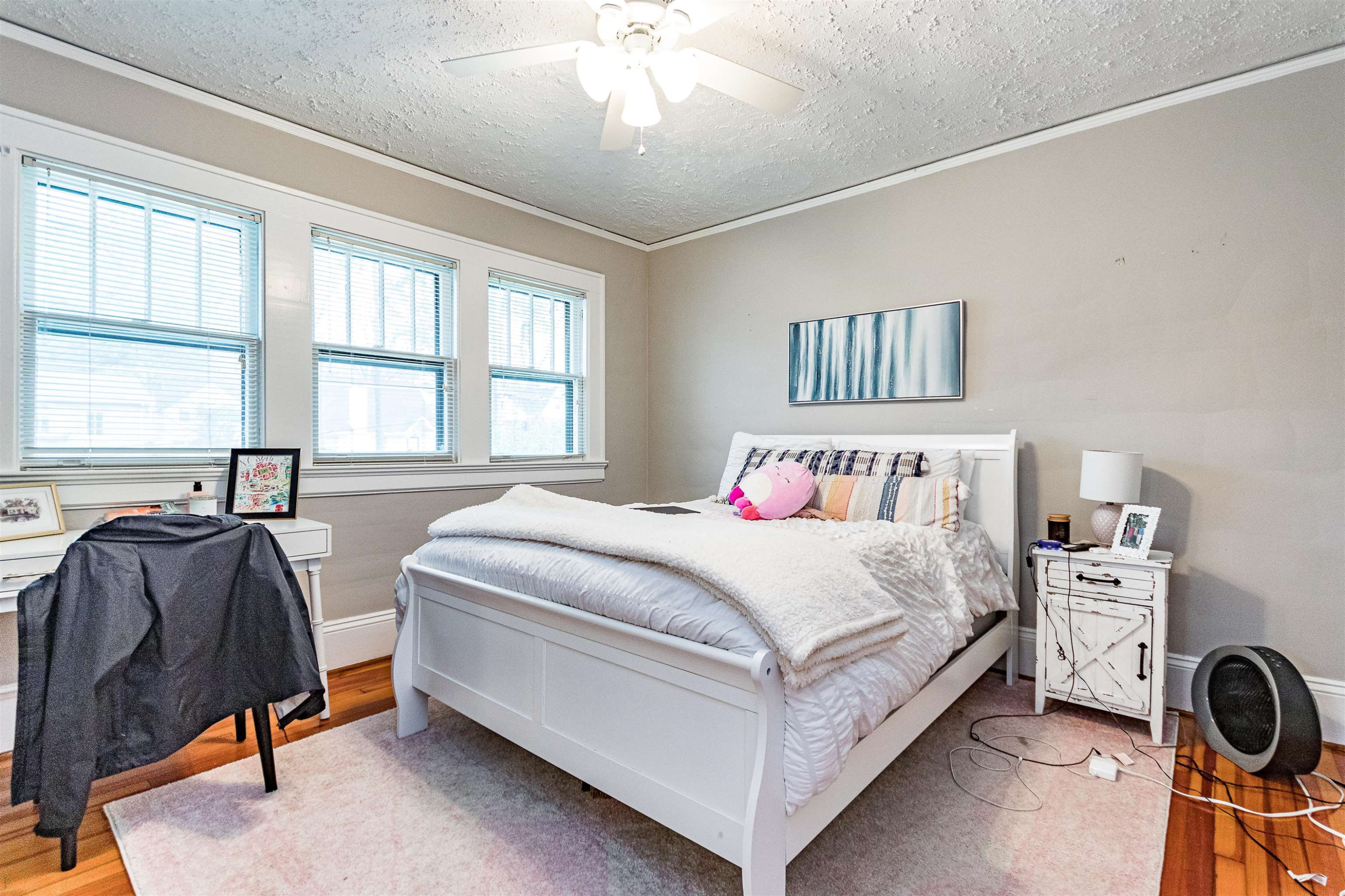 618 Brooks Avenue Raleigh, NC 27607 - Photo 16 of 27 a bedroom with a bed and a chandelier
