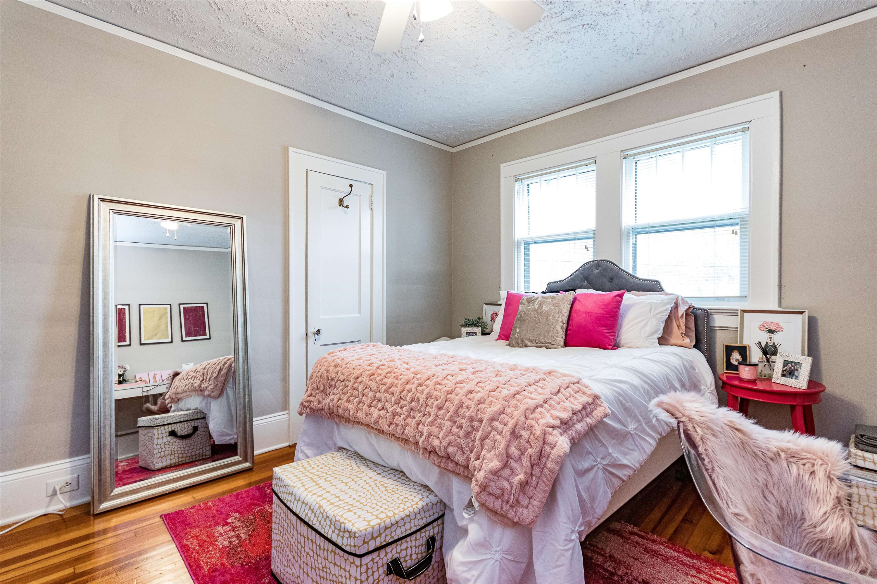 618 Brooks Avenue Raleigh, NC 27607 - Photo 20 of 27 a bedroom with a bed and wooden floor