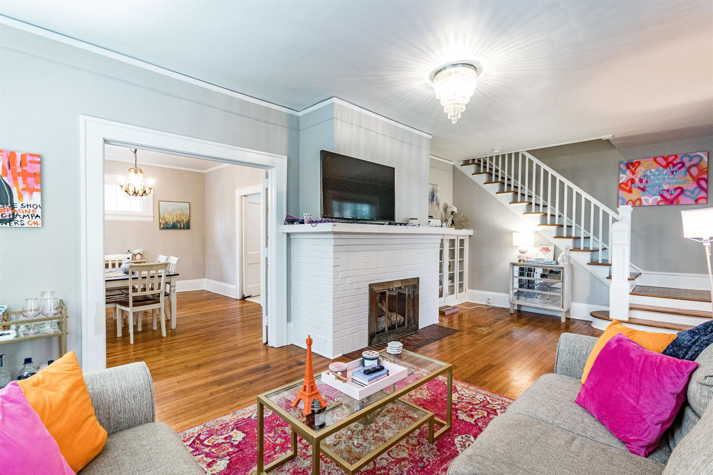618 Brooks Avenue Raleigh, NC 27607 - Photo 4 of 27 a living room with furniture a flat screen tv and a fireplace