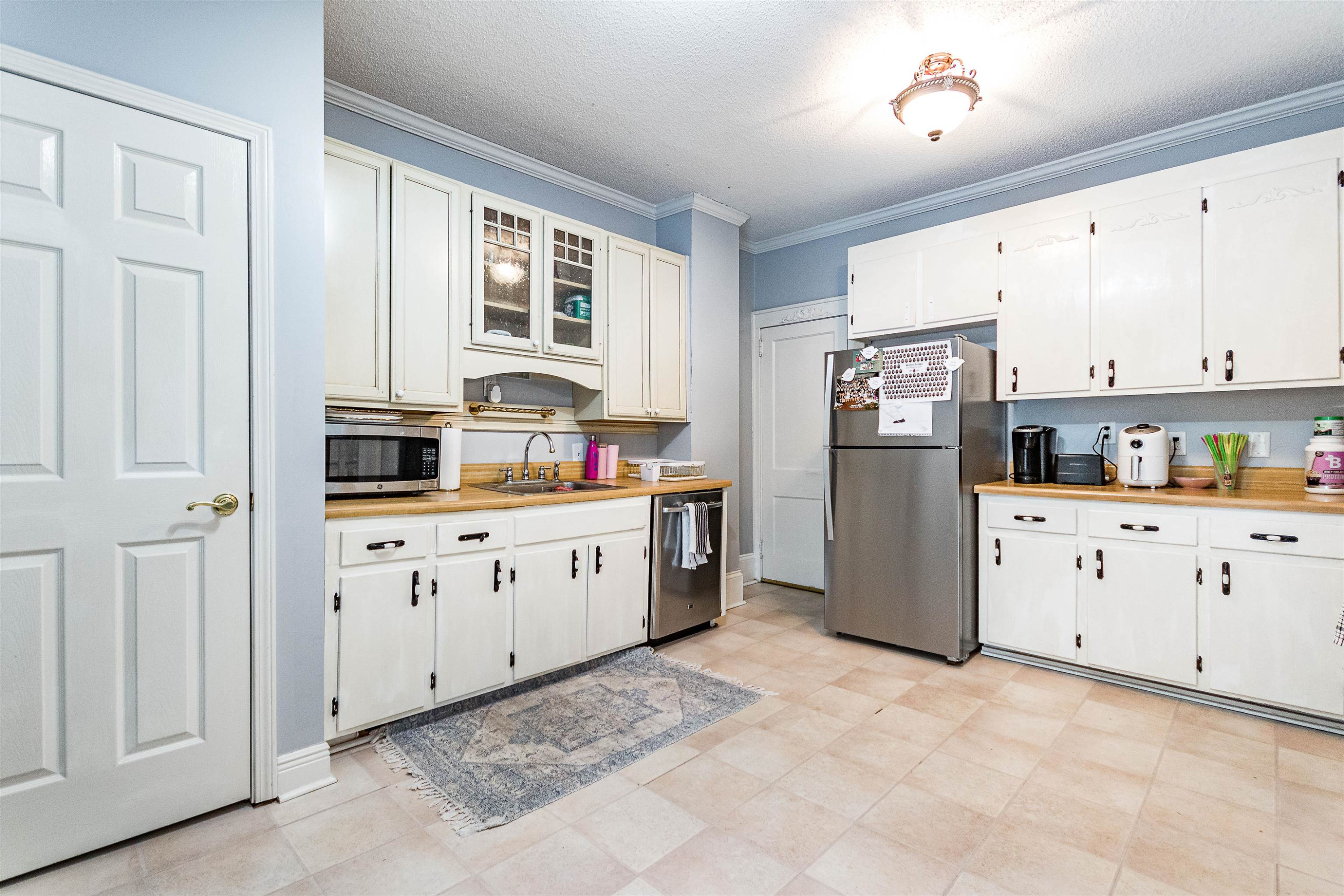 618 Brooks Avenue Raleigh, NC 27607 - Photo 8 of 27 a kitchen with refrigerator cabinets and window