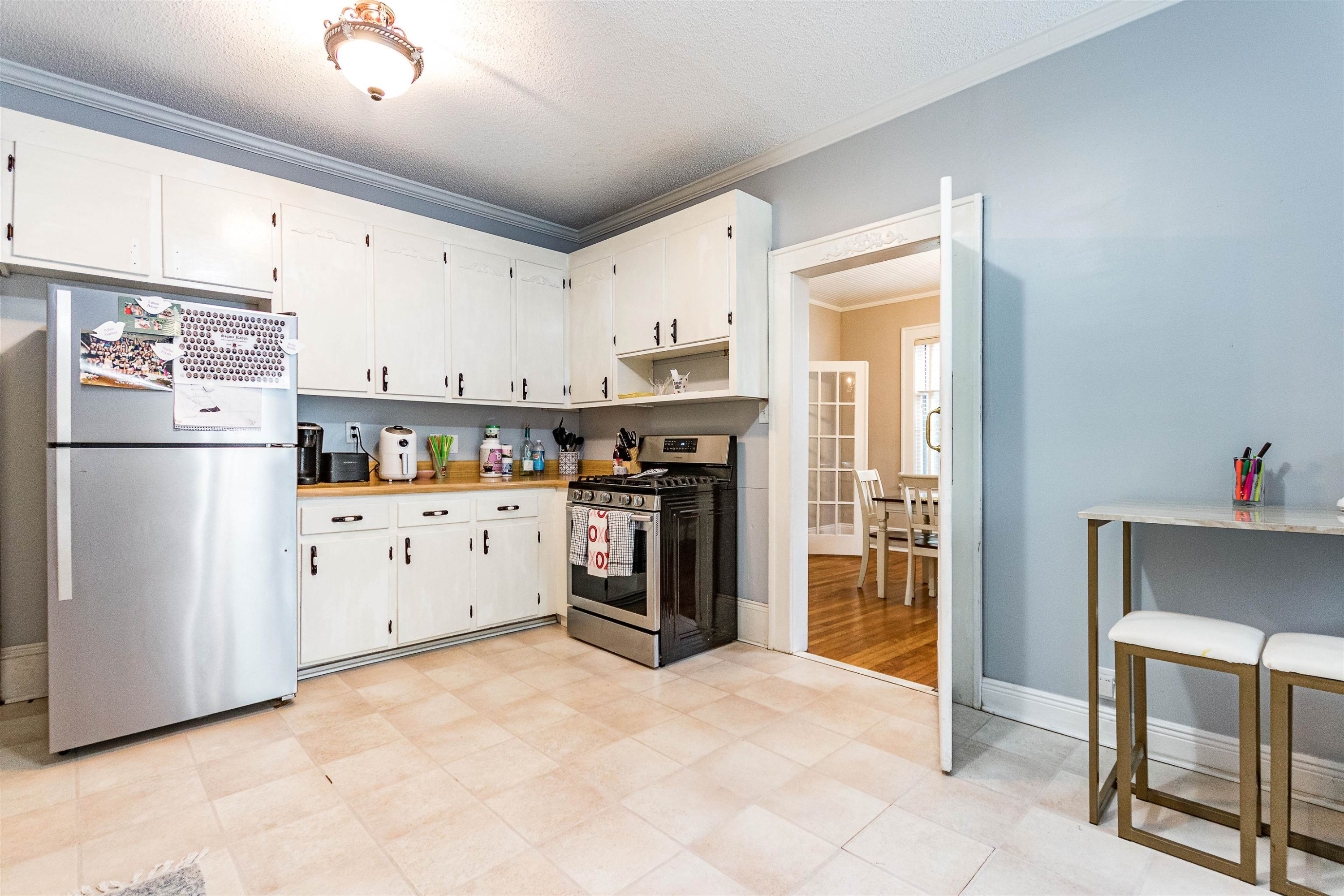 618 Brooks Avenue Raleigh, NC 27607 - Photo 9 of 27 a kitchen with stainless steel appliances a refrigerator sink and cabinets