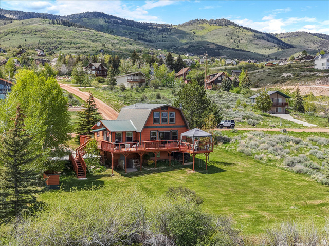 371 Lewis Loop, Unit 29 Fish Haven, ID 83287 - Photo 7 of 40 Mountain-style home featuring multiple levels of wood decking, a covered gazebo, and a metal roof