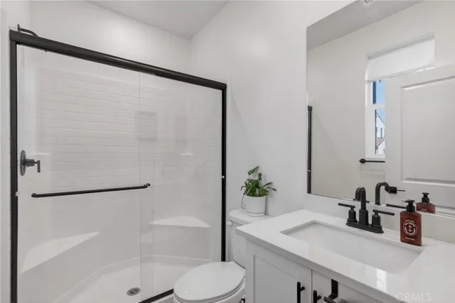 a view of entryway bedroom and hall with wooden floor