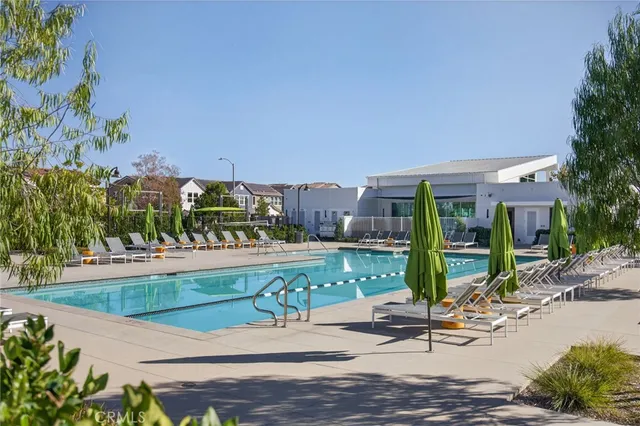 an aerial view of residential houses with outdoor space and swimming pool