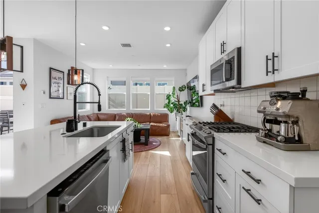 a kitchen with a sink appliances and cabinets