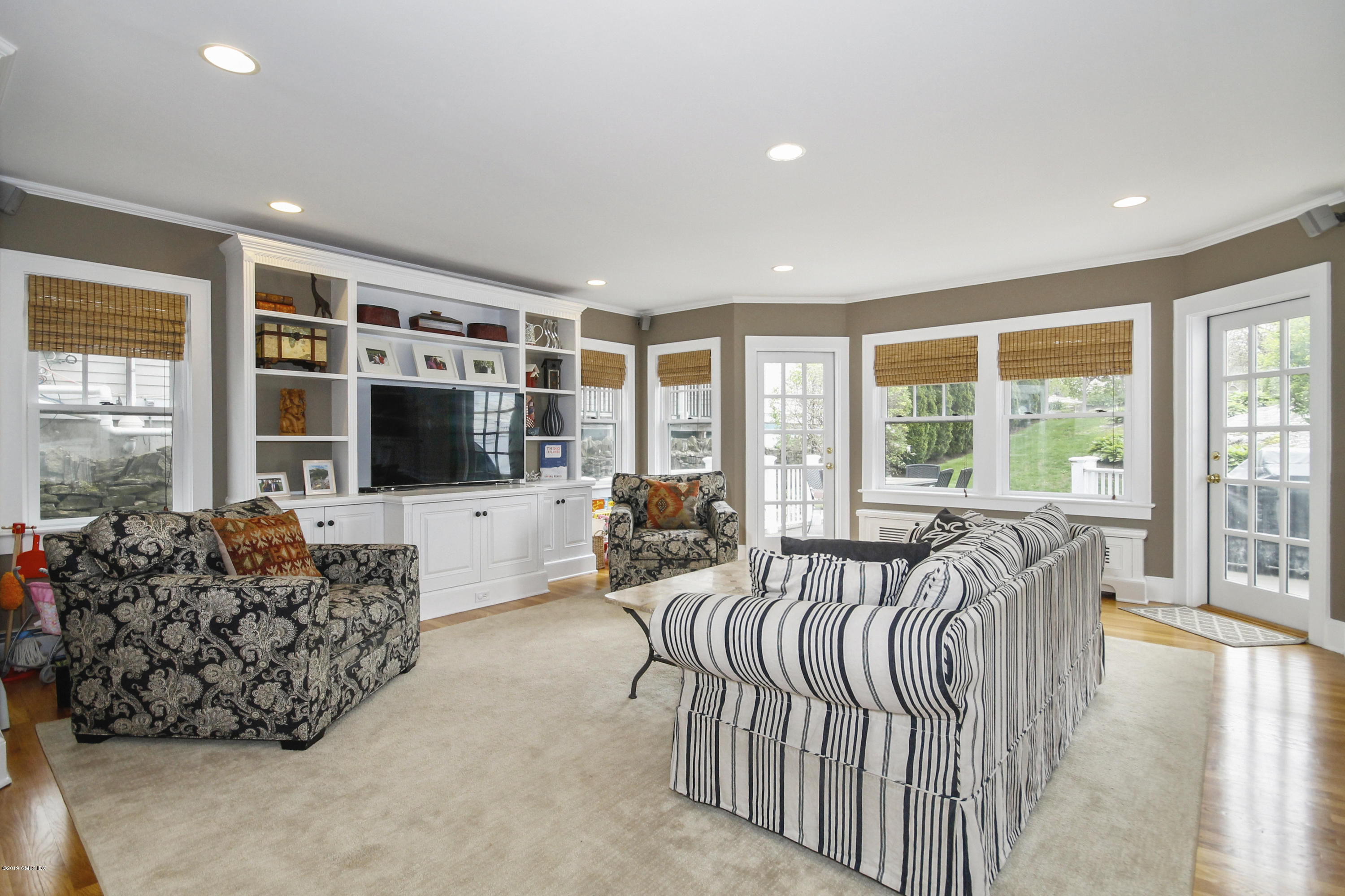 46 Orchard Place Greenwich, CT 06830 - Photo 13 of 34 a living room with furniture flat screen tv and floor to ceiling window