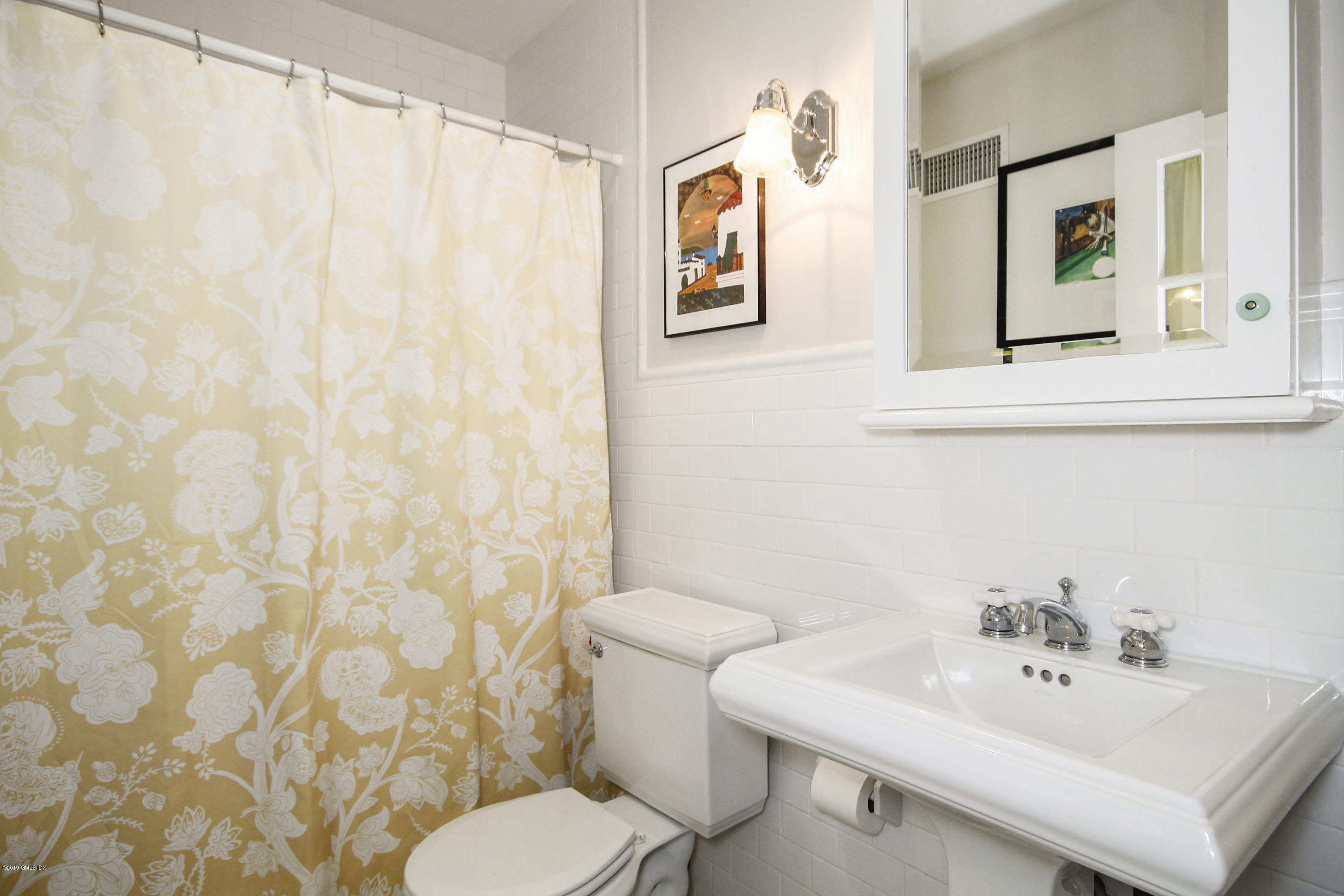 46 Orchard Place Greenwich, CT 06830 - Photo 17 of 34 a bathroom with a sink mirror and a toilet