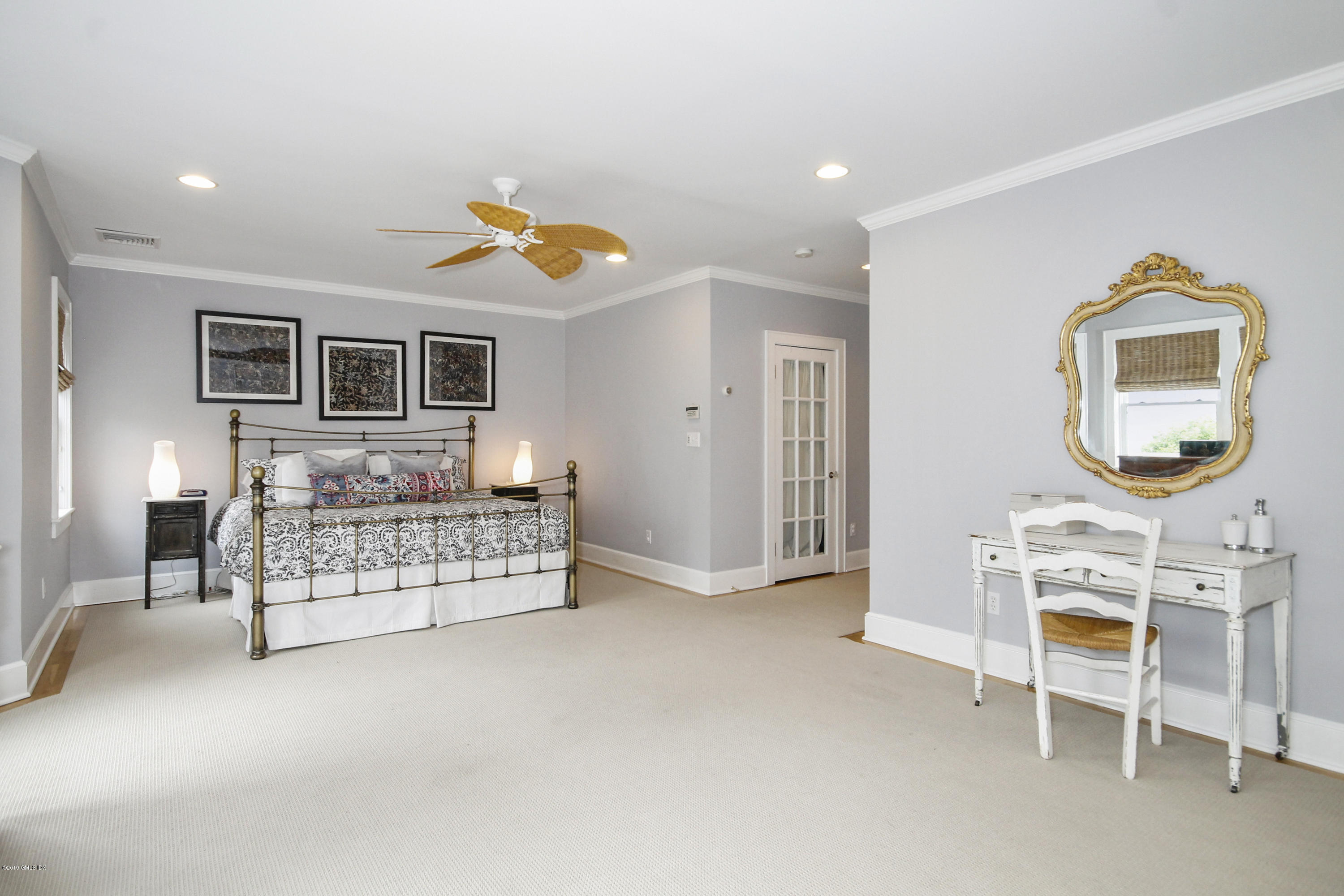 46 Orchard Place Greenwich, CT 06830 - Photo 21 of 34 a bedroom with furniture and a mirror