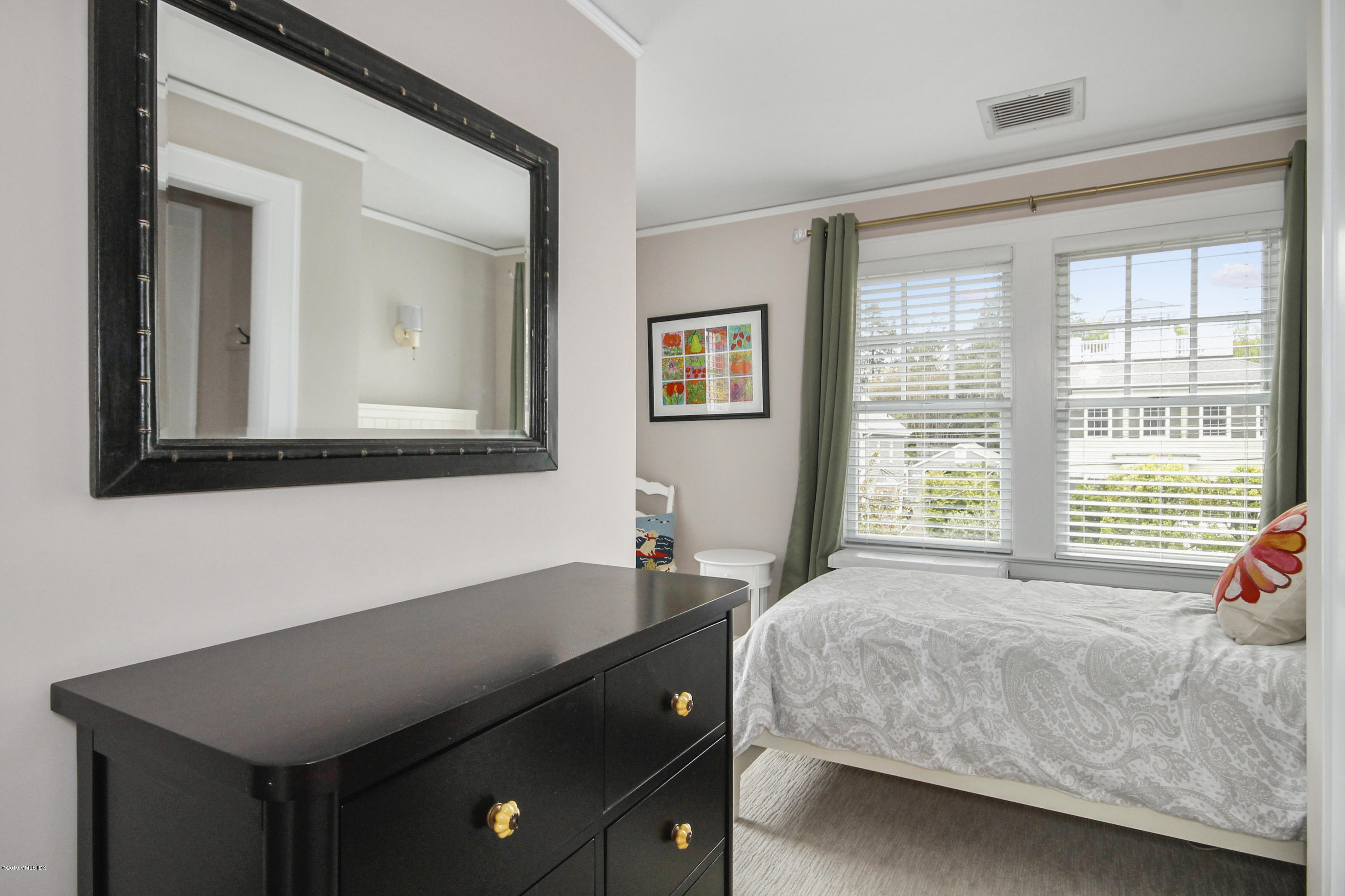 46 Orchard Place Greenwich, CT 06830 - Photo 23 of 34 a bedroom with a bed and a window