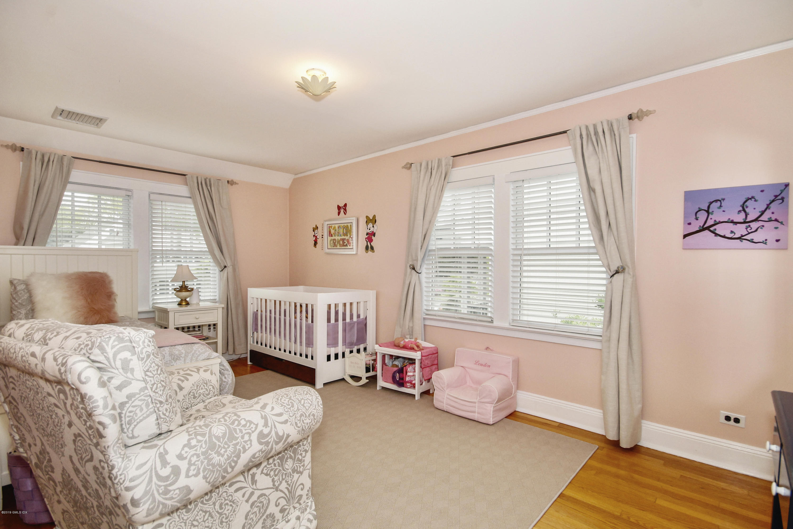 46 Orchard Place Greenwich, CT 06830 - Photo 25 of 34 a bedroom with a bed and a window