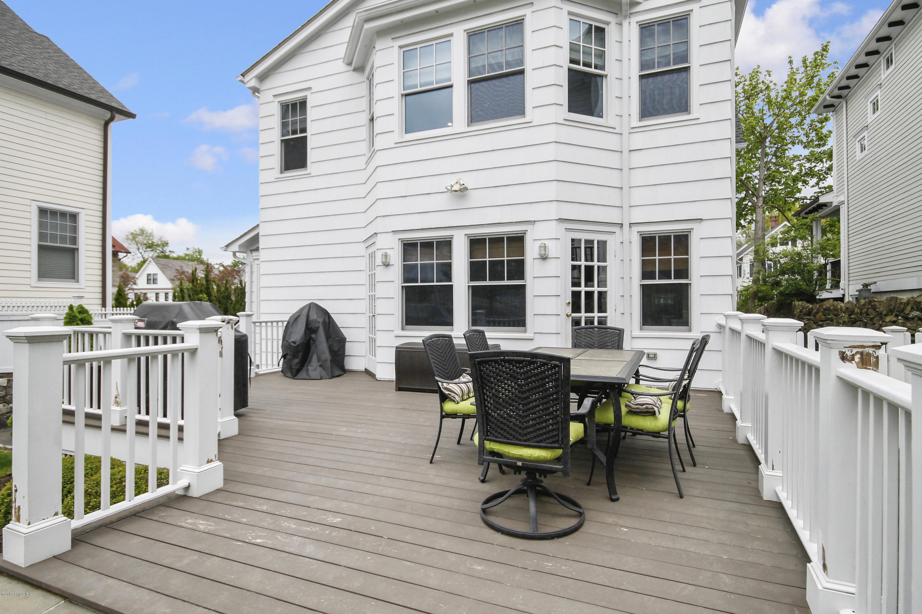 46 Orchard Place Greenwich, CT 06830 - Photo 30 of 34 a view of a deck with table and chairs and wooden floor