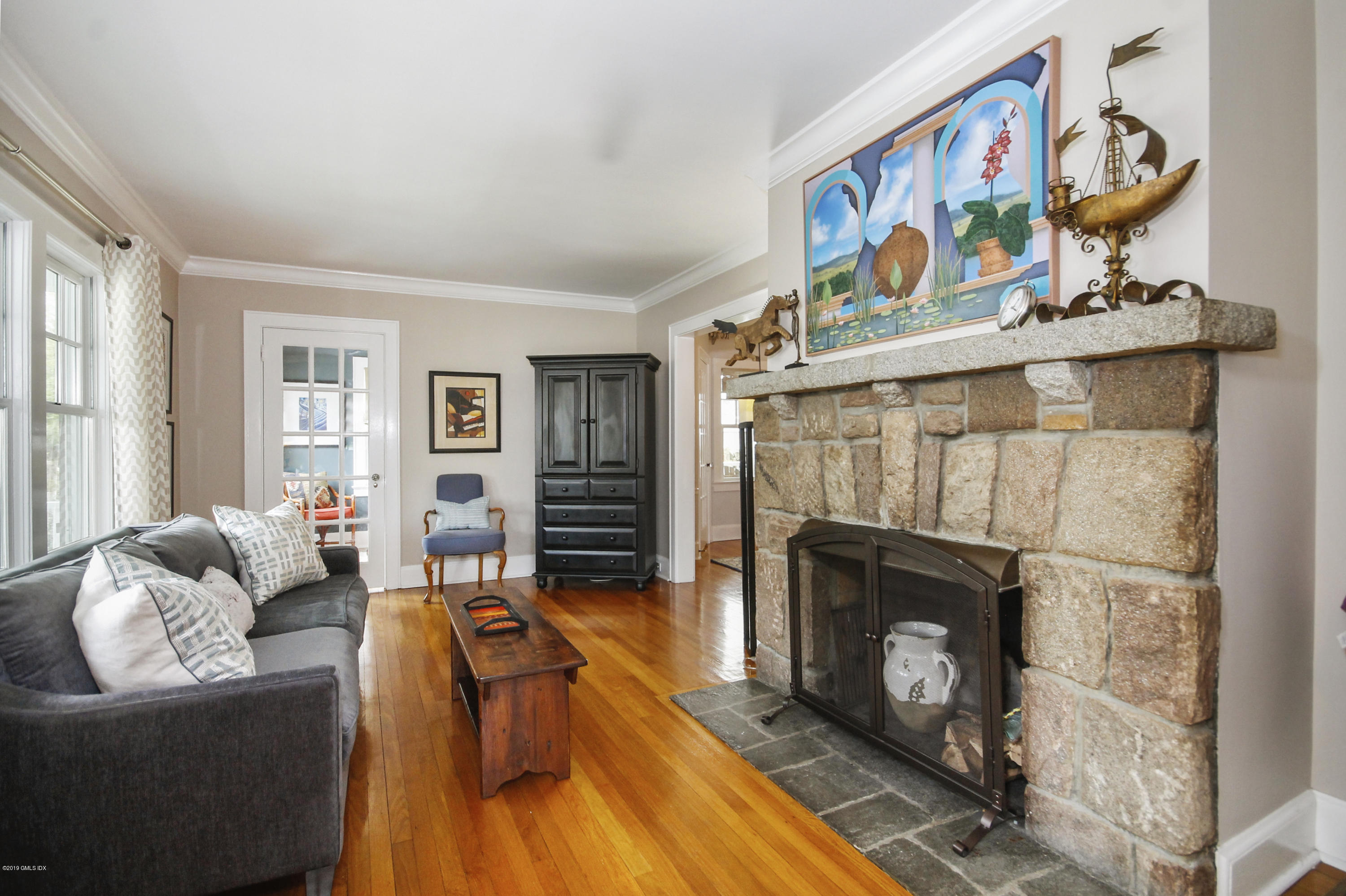 46 Orchard Place Greenwich, CT 06830 - Photo 3 of 34 a living room with furniture a flat screen tv and a fireplace