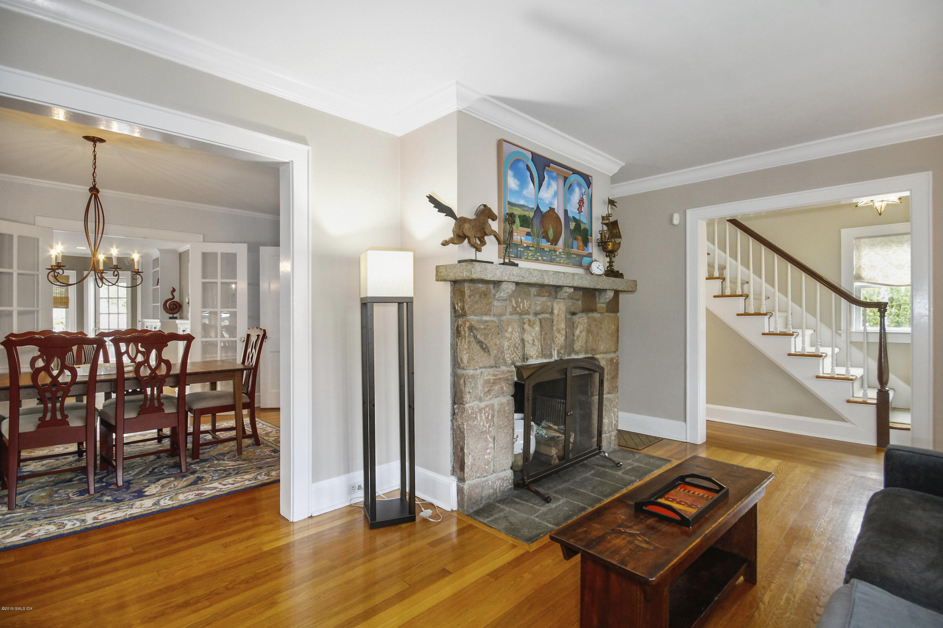 46 Orchard Place Greenwich, CT 06830 - Photo 5 of 34 a living room with furniture a fireplace and a table