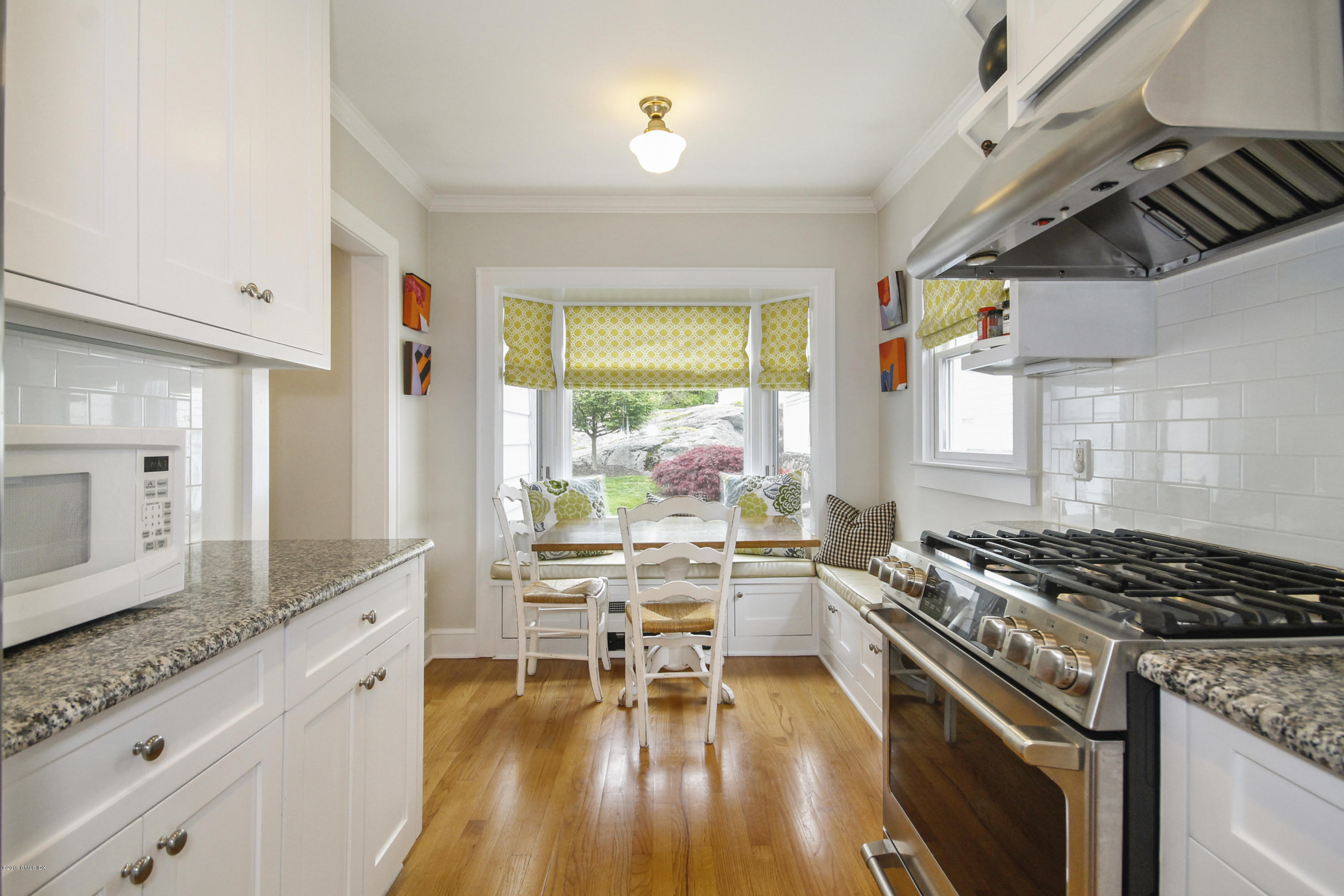 46 Orchard Place Greenwich, CT 06830 - Photo 9 of 34 a kitchen with stainless steel appliances granite countertop a stove and white cabinets