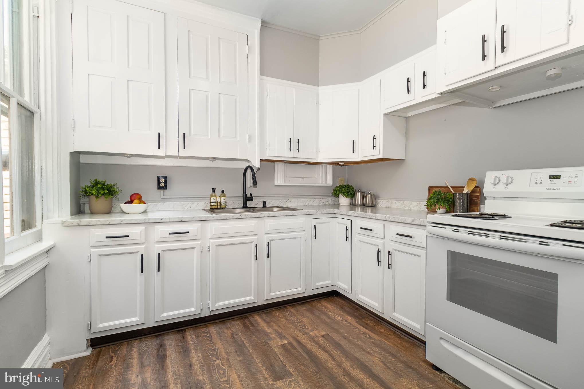 549 Spruce Street Lancaster, PA 17603 - Photo 11 of 29 a kitchen with granite countertop white cabinets and white appliances