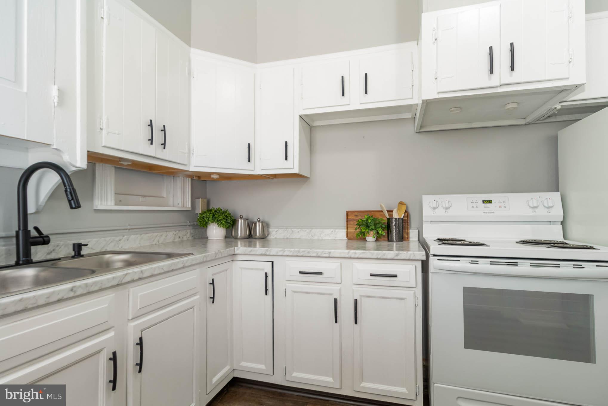 549 Spruce Street Lancaster, PA 17603 - Photo 12 of 29 a kitchen with cabinets appliances a sink and a counter top