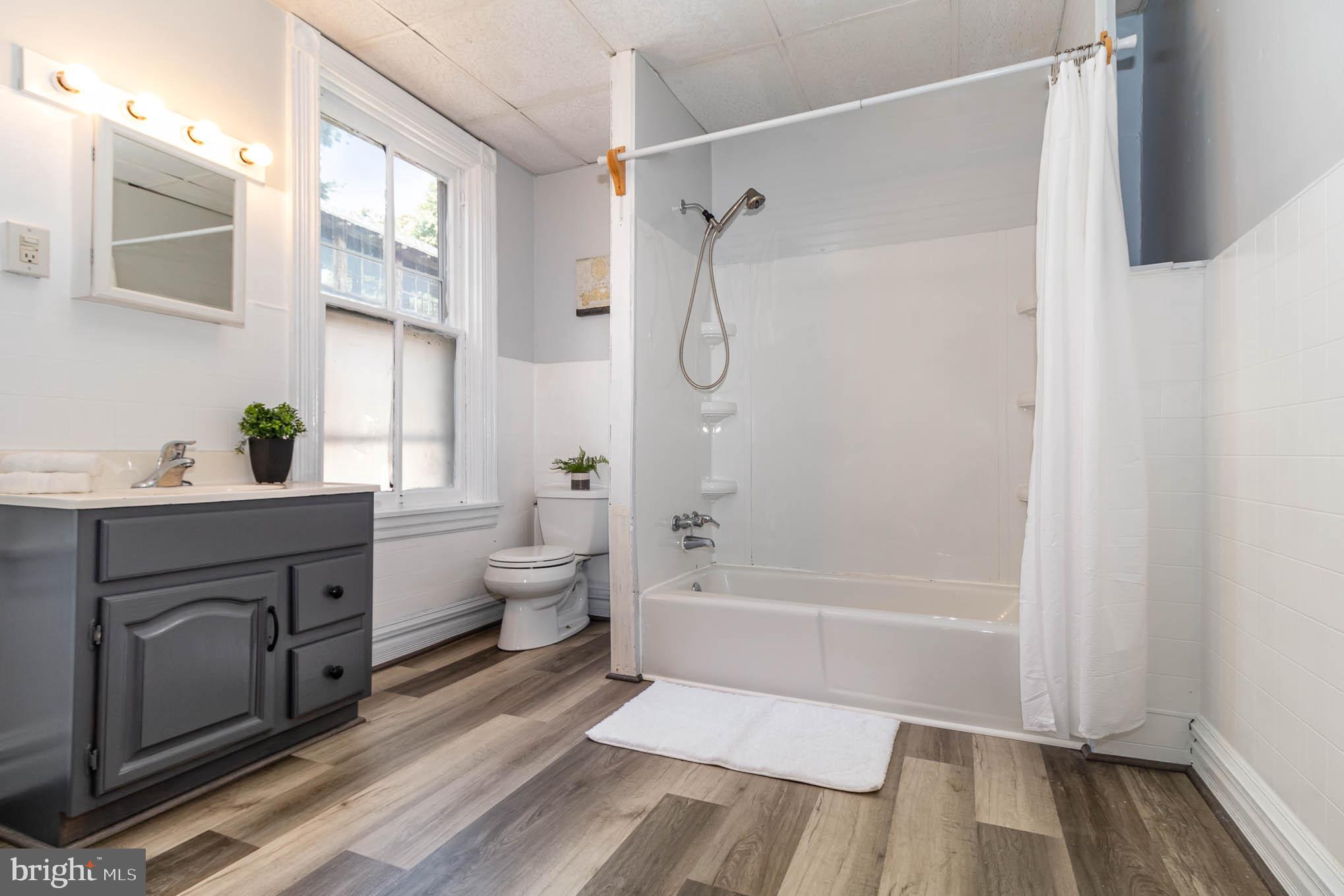549 Spruce Street Lancaster, PA 17603 - Photo 14 of 29 a spacious bathroom with a granite countertop sink a toilet and shower