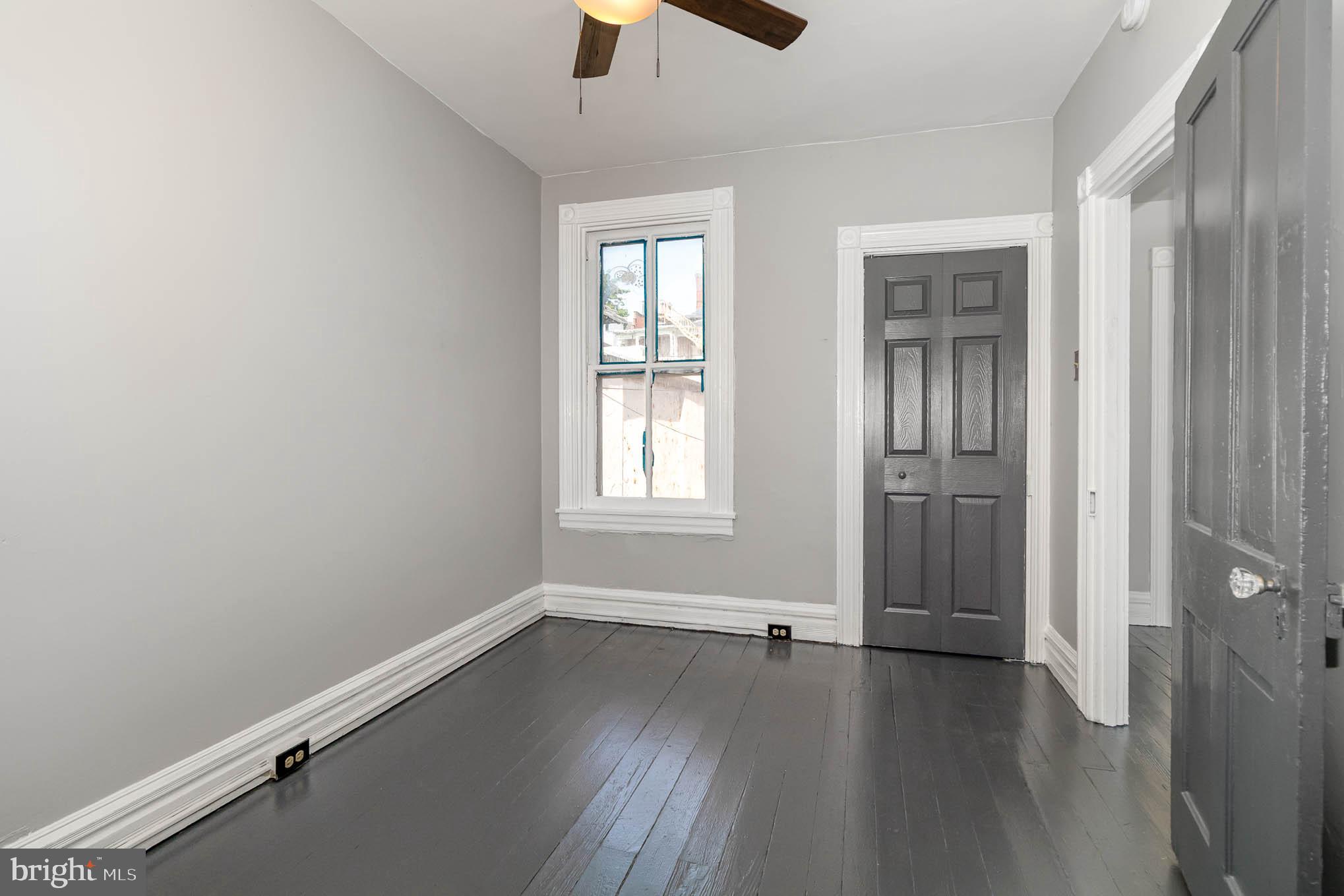 549 Spruce Street Lancaster, PA 17603 - Photo 16 of 29 an empty room with wooden floor and windows