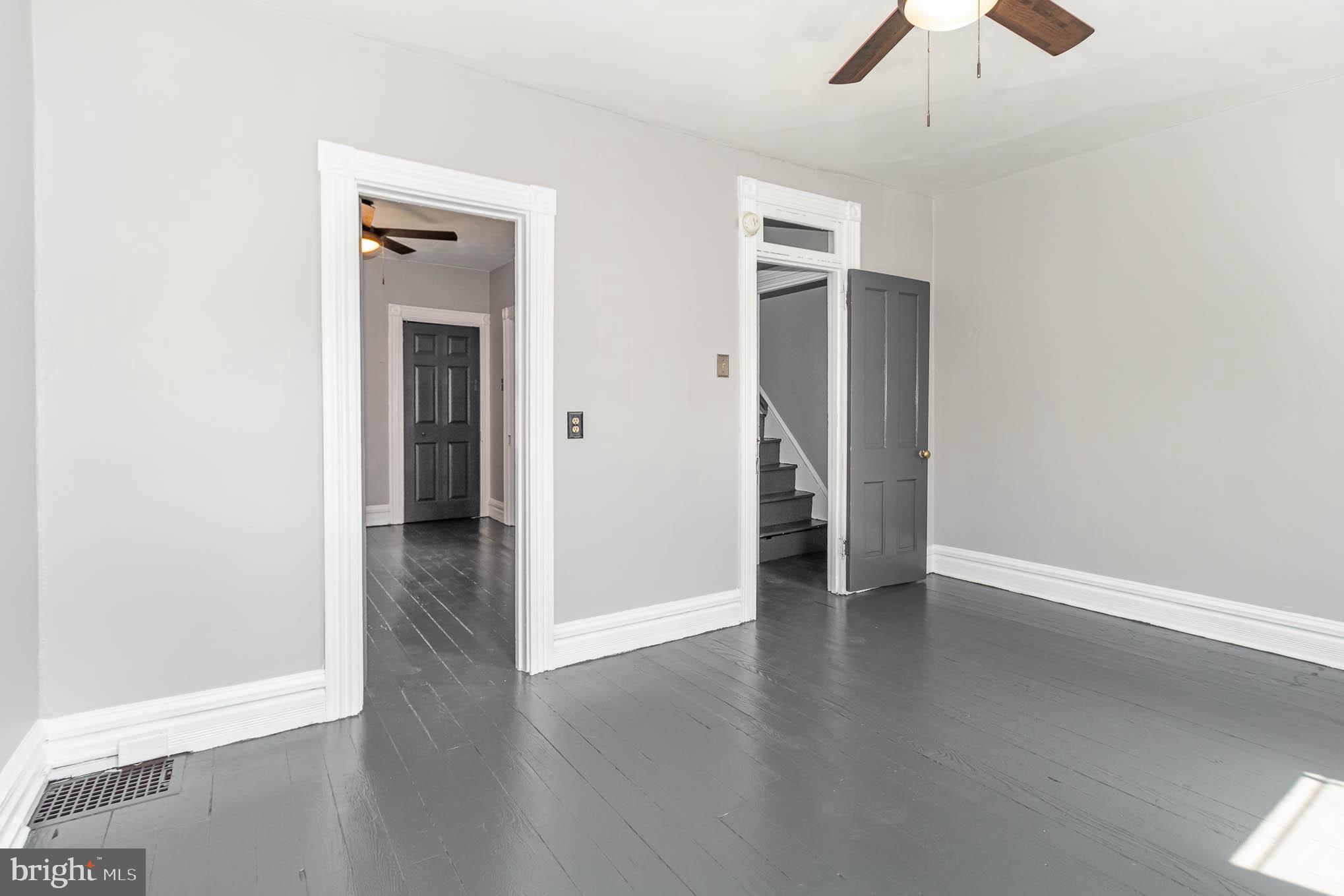 549 Spruce Street Lancaster, PA 17603 - Photo 19 of 29 an empty room with wooden floor a ceiling fan and a window