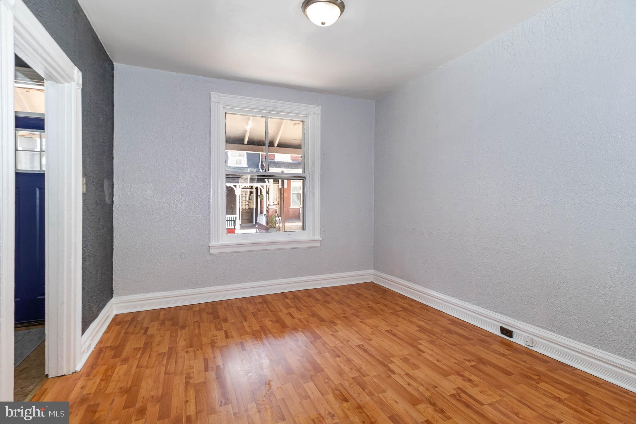 549 Spruce Street Lancaster, PA 17603 - Photo 5 of 29 an empty room with wooden floor and windows