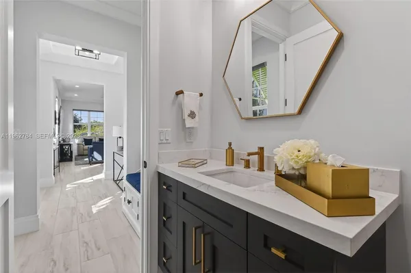 a kitchen with white cabinets stainless steel appliances and sink