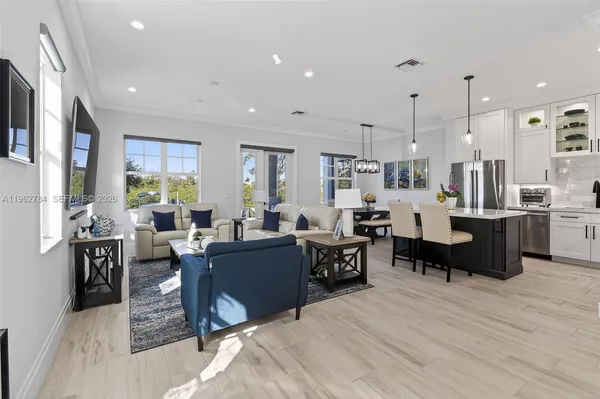 a kitchen with granite countertop a sink stainless steel appliances and cabinets