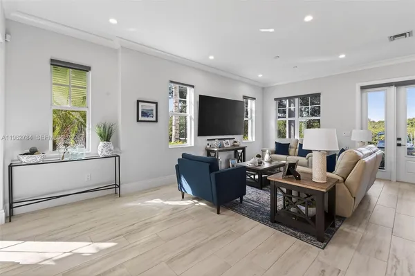 a view of a dining room with furniture wooden floor and chandelier