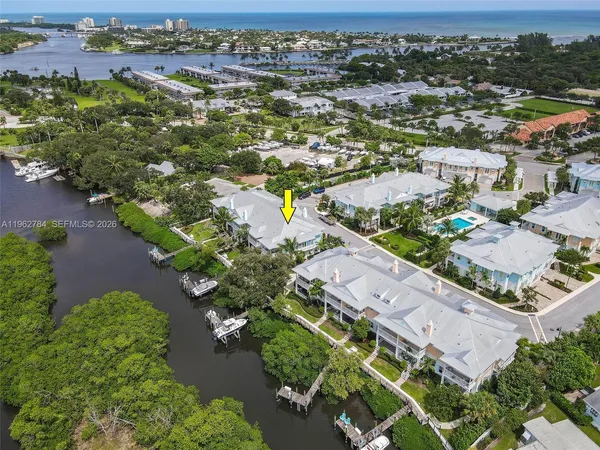an aerial view of a house with swimming pool patio and lake view