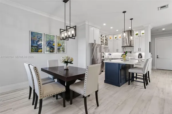 a spacious bedroom with a large bed and a potted plant