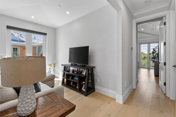a bedroom with a flat screen tv and a bed