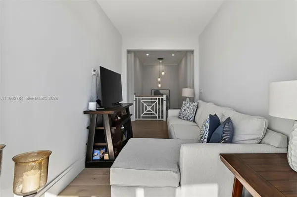 a utility room with stainless steel appliances granite countertop a sink a stove and cabinets