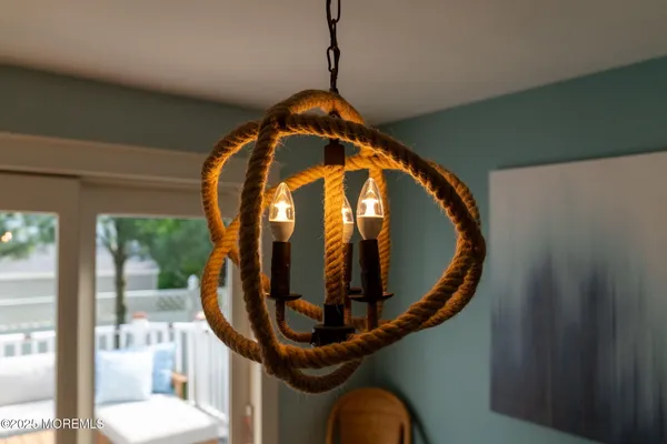a view of a dining room with furniture and chandelier