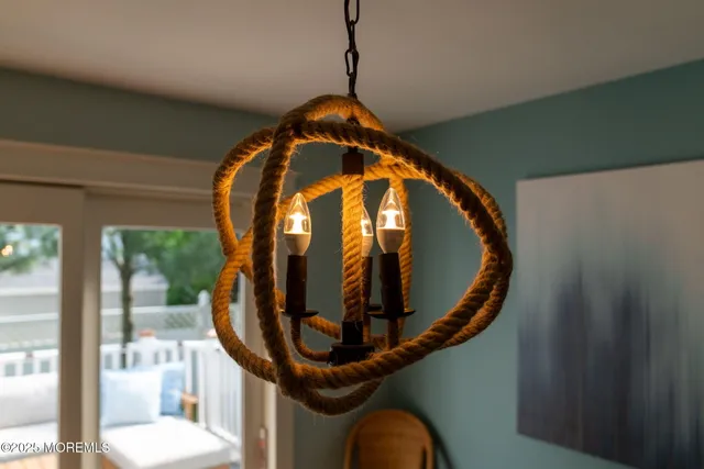 a view of a dining room with furniture and chandelier