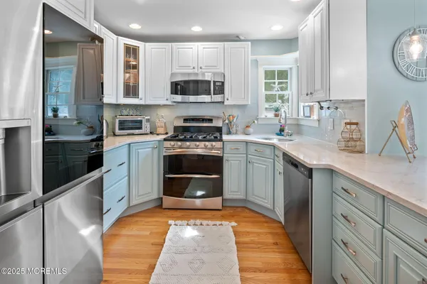a kitchen with stainless steel appliances a stove sink and microwave