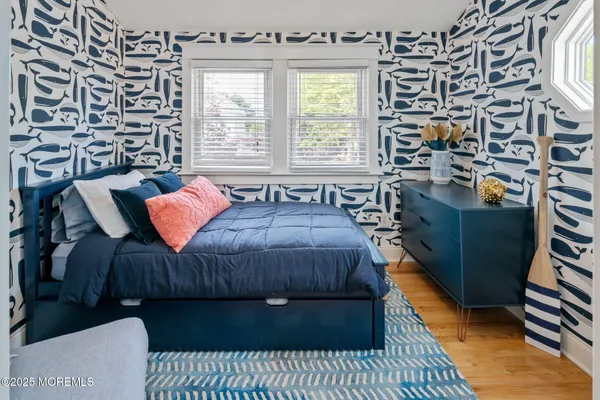 a bedroom with a bed and a night stand