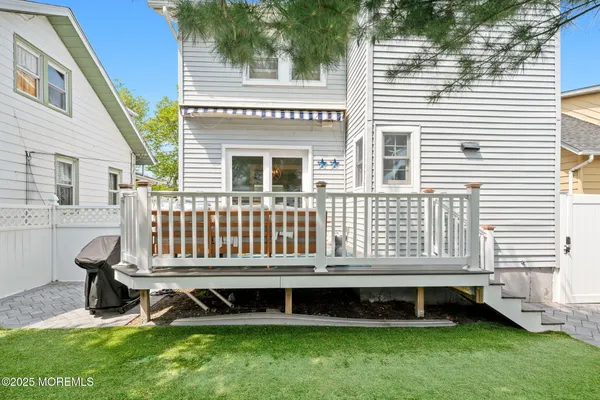 a view of a chair and table in backyard of the house