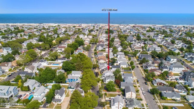 a view of a house with backyard and a tree