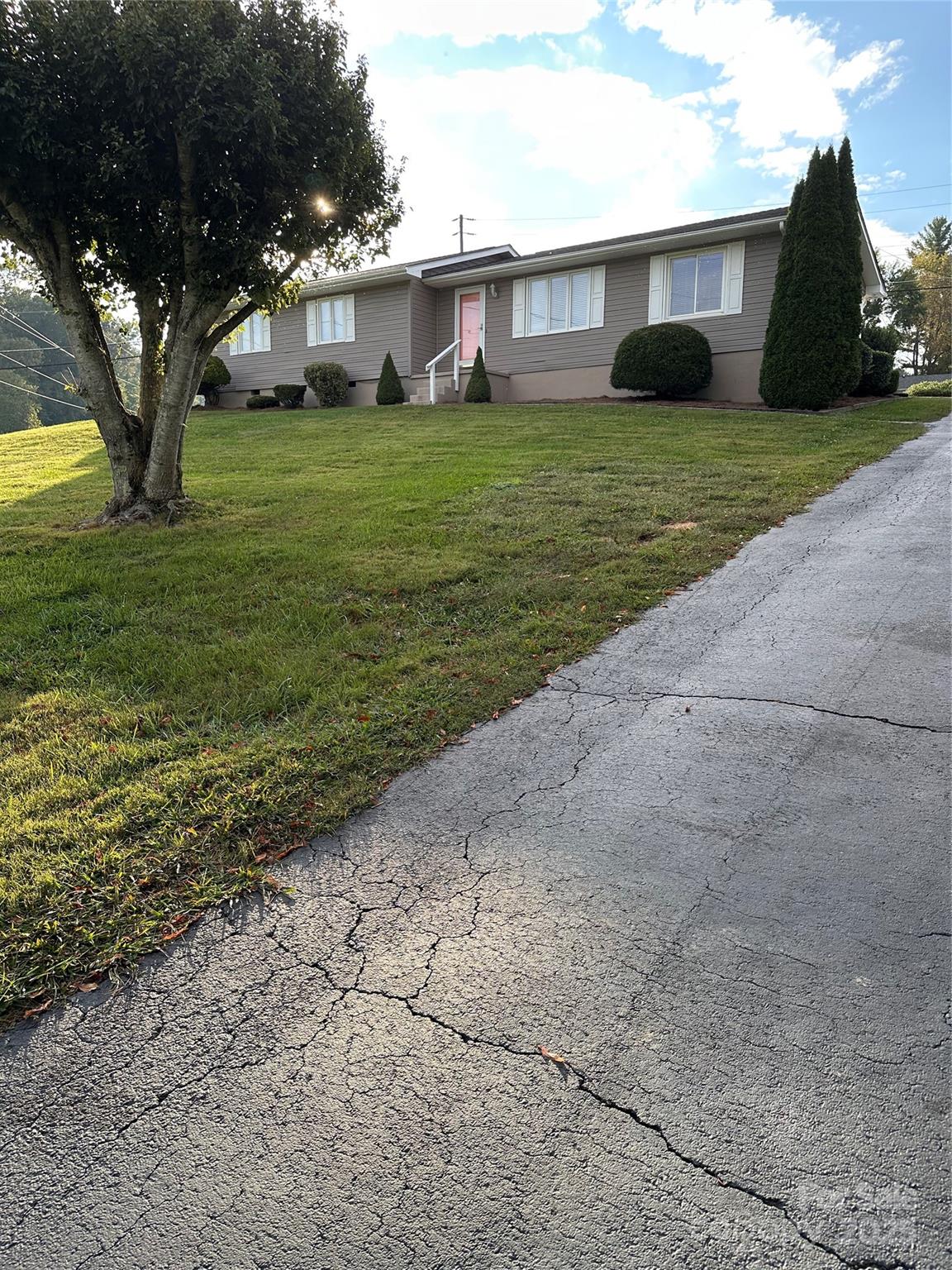 450 Case Cove Road, Unit 85 Candler, NC 28715 - Photo 1 of 14 a front view of a house with a garden and trees