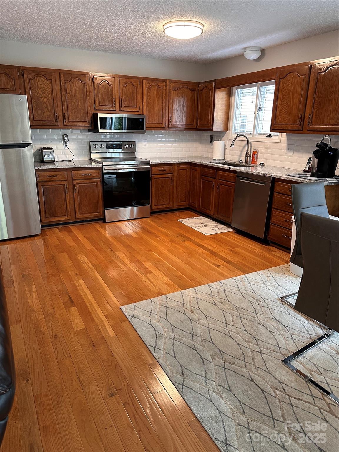 450 Case Cove Road, Unit 85 Candler, NC 28715 - Photo 3 of 14 a kitchen with stainless steel appliances a sink window and cabinets