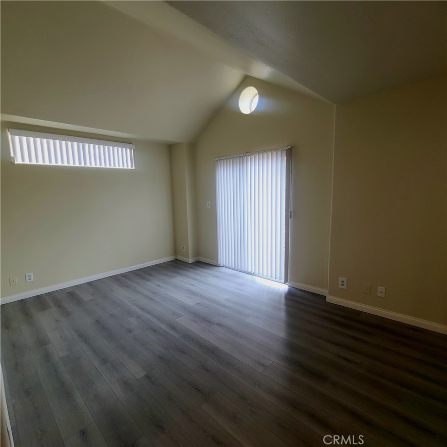 5060 Kester Avenue, Unit 208 Sherman Oaks, CA 91403 - Photo 11 of 31 an empty room with wooden floor and windows